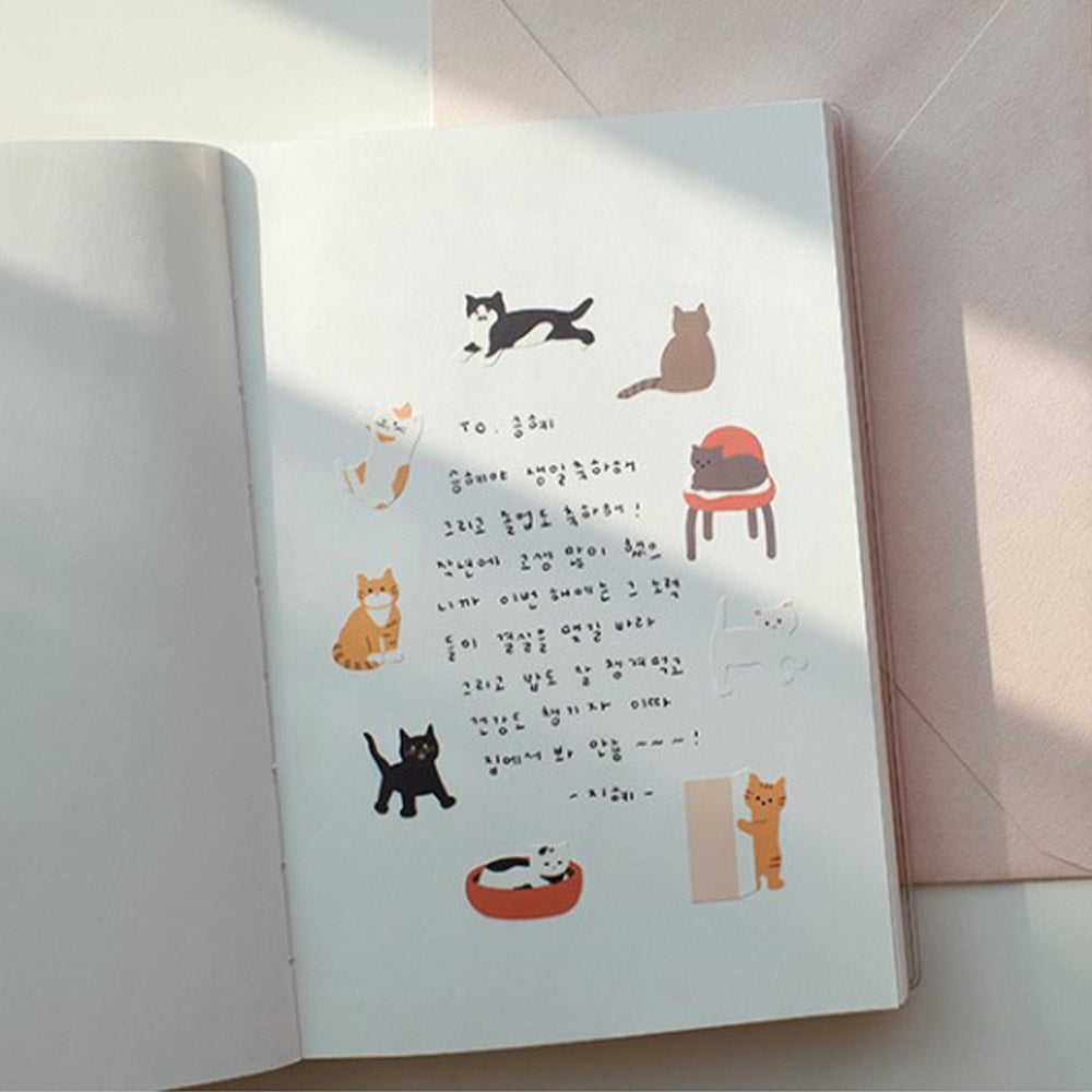 Suatelier Cats Have Staff stickers applied in a notebook with handwritten notes