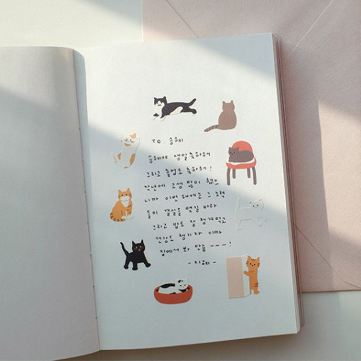 Suatelier Cats Have Staff stickers applied in a notebook with handwritten notes