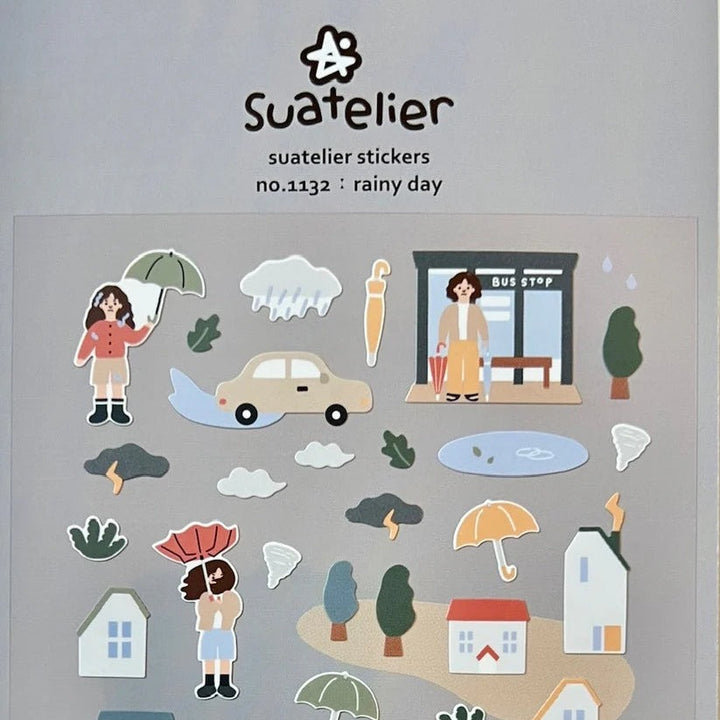 Close-up of Suatelier Rainy Day stickers with umbrellas, houses and people
