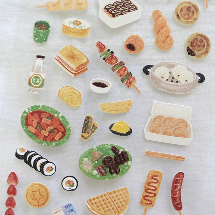 Close-up of Suatelier Street Food stickers with skewers, dumplings and snacks