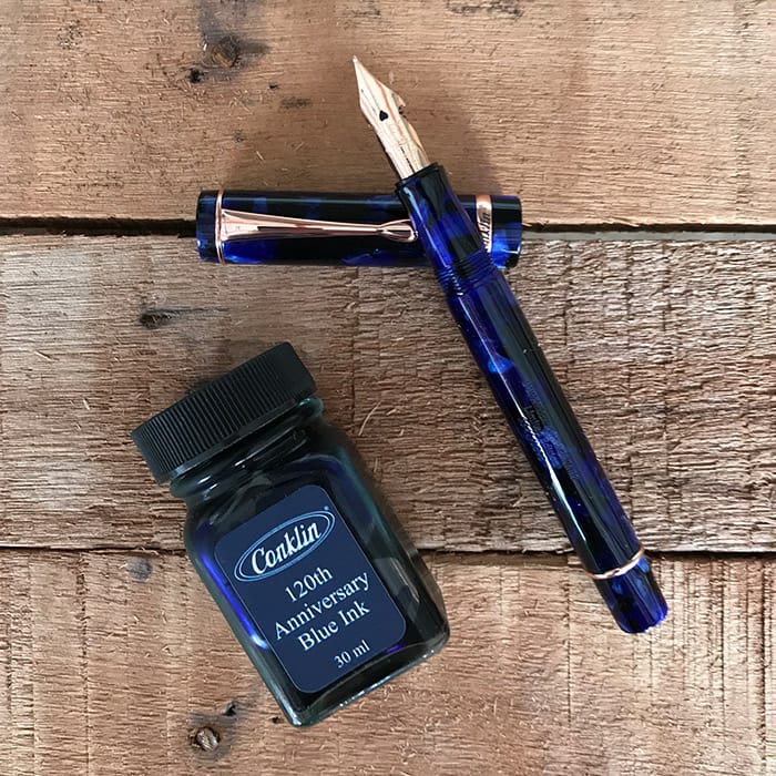 Conklin Duraflex 120th Anniversary Fountain Pen (Rose Gold Flex Nib) — writing at an angle